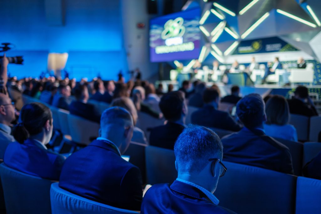 attentive,audience,listens,as,experts,discuss,global,trends,at,an